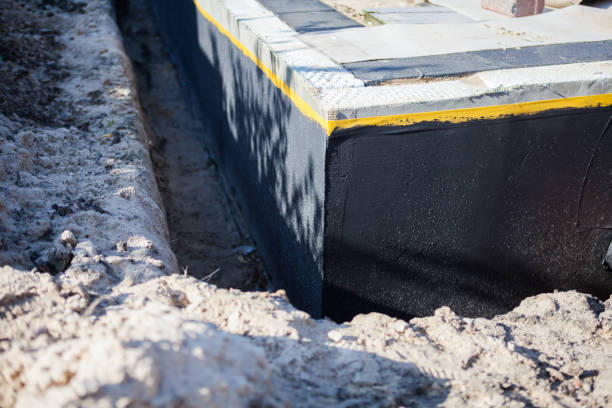 Professional Basement Waterproofing technician working in Lansing, KS